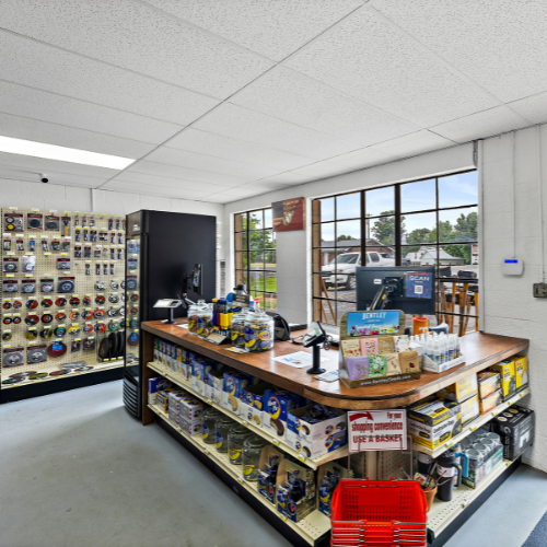  Checkout counter lined with Moon Pies and contractor garbage bags. Behind the counter is a window facing the parking lot. To the left, there's a refrigerator and a display of saw blades.