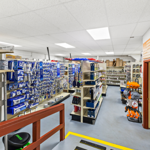 Aisles filled with plumbing supplies, mostly in royal blue packaging. Fixtures are mainly white and grey, including items for water supply, sinks, faucets, toilet repair, tubular drainage, and more.