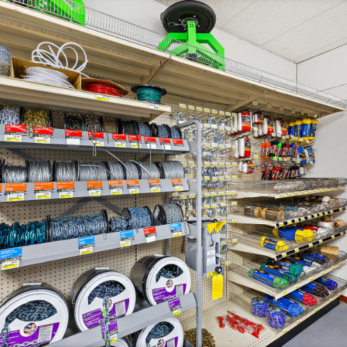 Our selection of metal chains on one side of a shelf, and our selection of ropes on the other side.