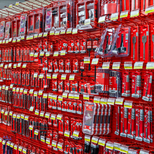 A small selection of our Milwaukee tool bits, with shelves featuring a Milwaukee red background.