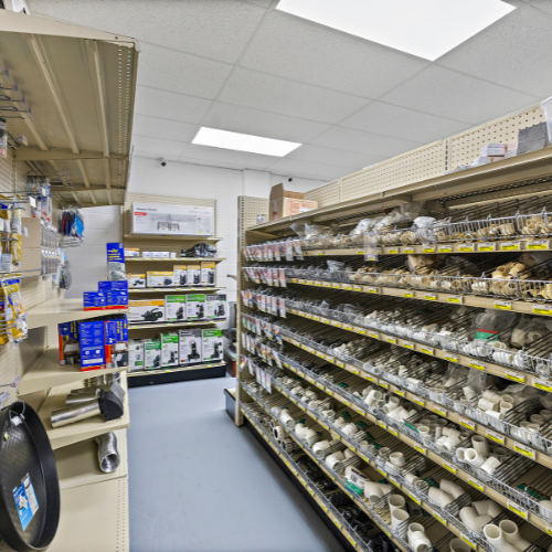 Our selection of pipes and pipe fittings neatly sorted on a shelf in our plumbing department.