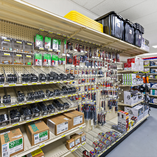 An aisle filled with meters, thermometers, security area lights, fire extinguishers, flush mount ceiling lights, and more.